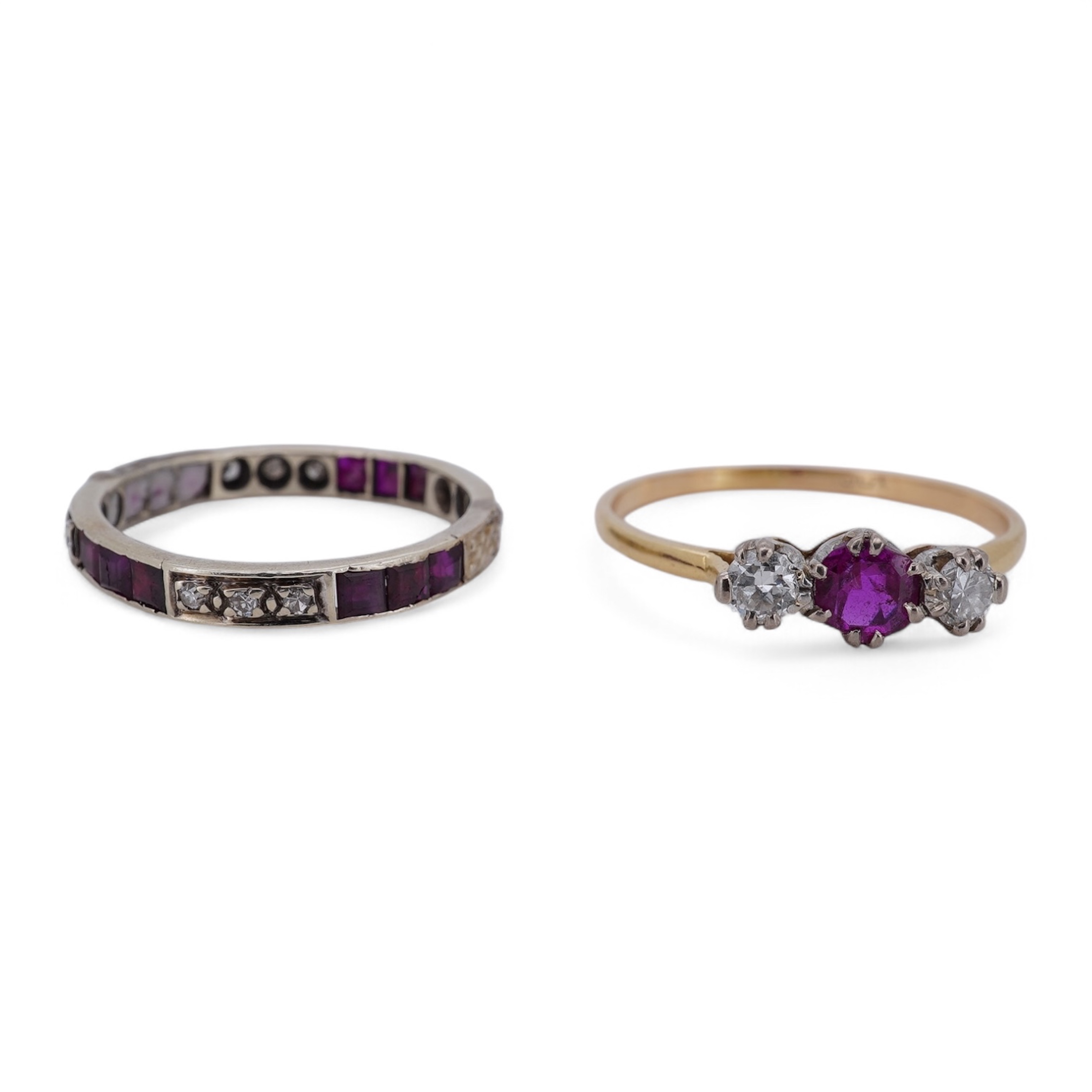 A yellow metal, stamped 18ct, ruby and diamond set three stone ring, size W, together with a yellow metal ruby and diamond set full eternity ring, size Q, gross weight 4.4 grams. Condition - poor to fair